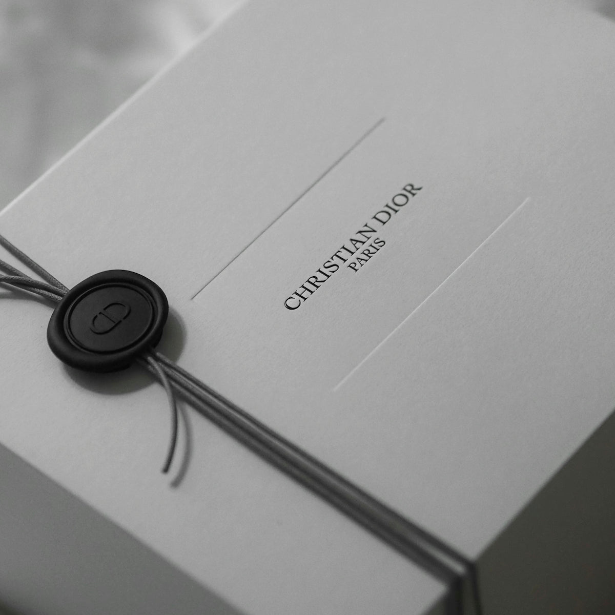 White christian dior gift box with ribbon and wax seal