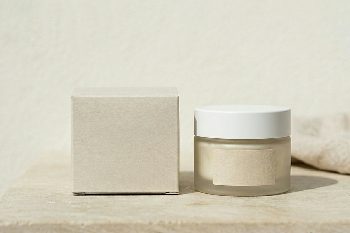 Frosted glass jar and box on a light surface.