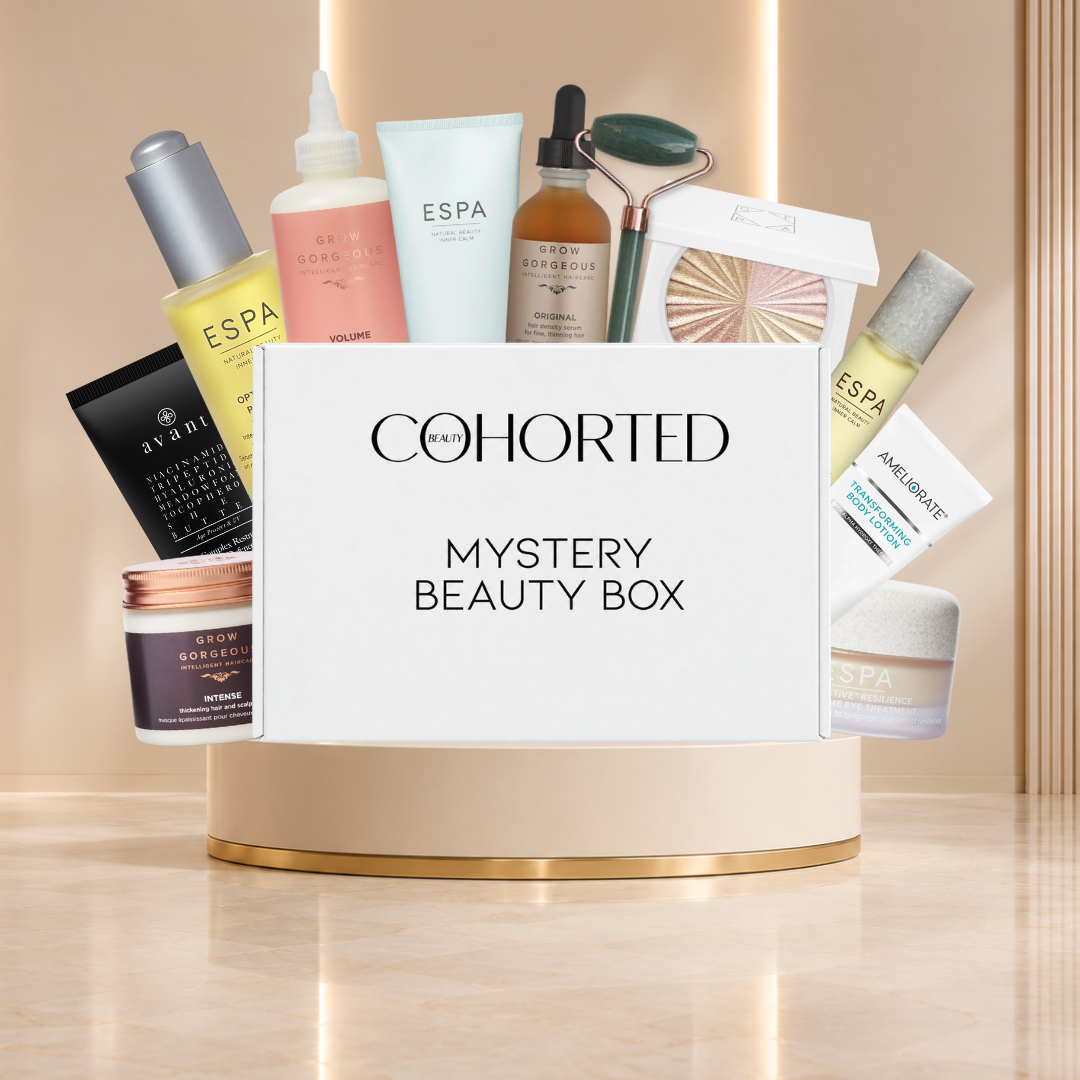 Cohorted First Edition Mystery Beauty Box gift set with assorted skincare and makeup products in a branded box.