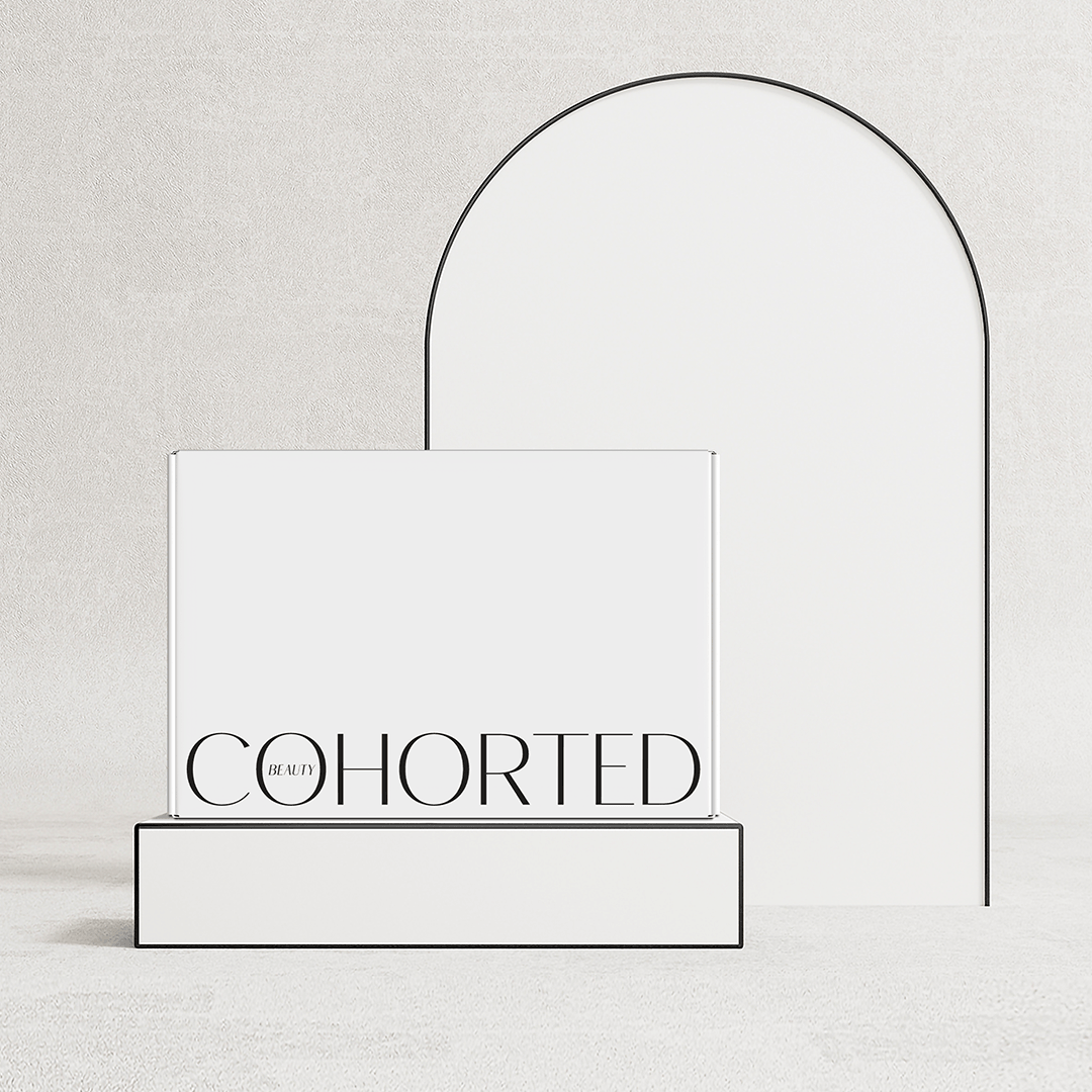 Cohorted subscription beauty box featuring a variety of skincare and makeup products arranged inside the box.